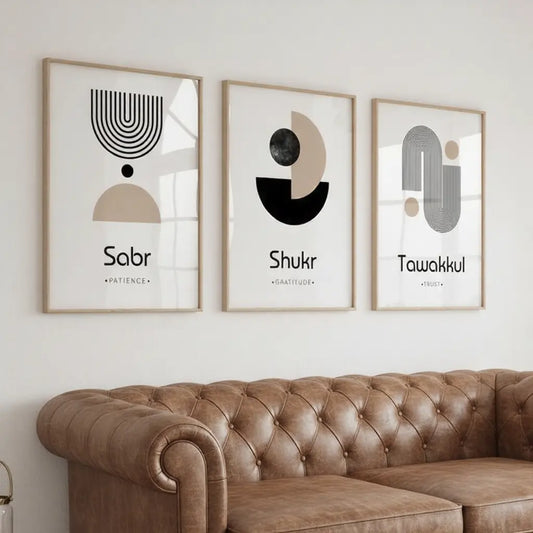 Three framed abstract artworks on a wall above a brown leather sofa.