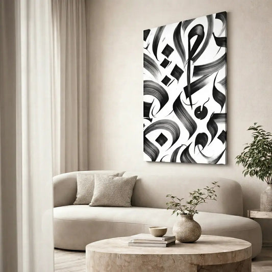 Abstract black and white artwork on a wall above a beige sofa in a living room.